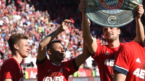Bayern Munich's Brazilian defender Rafinha (C) toasts their league success