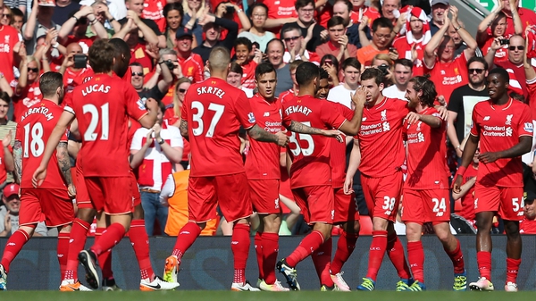 Joe Allen of Liverpool (2R) celebrates with his team-mates after he put the hosts in front