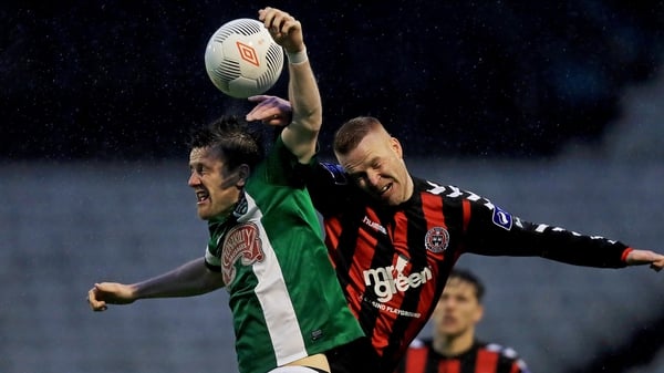 Lorcan Fitzgerald of Bohs battles in the air with with Steven Beattie of Cork