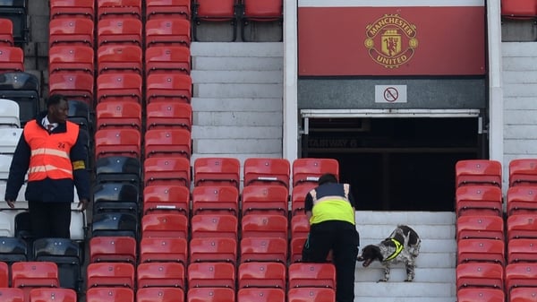 A sniffer dog searches the stands at Old Trafford in Manchester