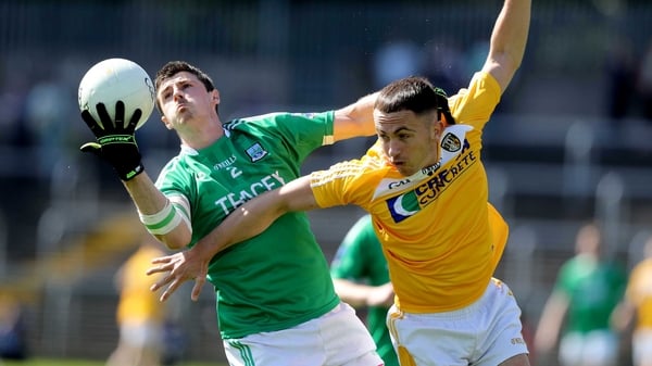 Fermanagh's Mickey Jones with Brian Neeson of Antrim tangle for possession