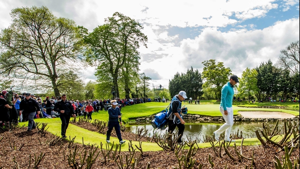 Rory McIlroy (R) makes his way to the eighth tee at the K Club yesterday
