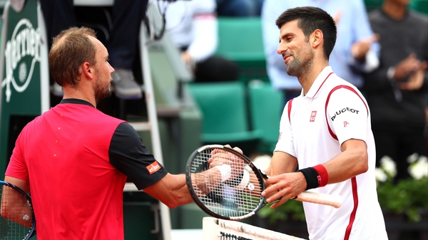 Novak Djokovic shakes hands with Steve Darcis afterwards
