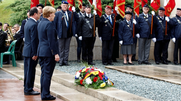 French President Francois Hollande and German Chancellor Angela Merkel lay a wreath to mark the centenary at Verdun, France