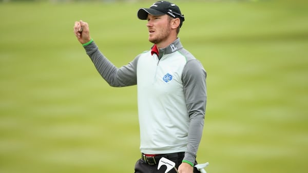 Chris Wood celebrates victory on the 18th green