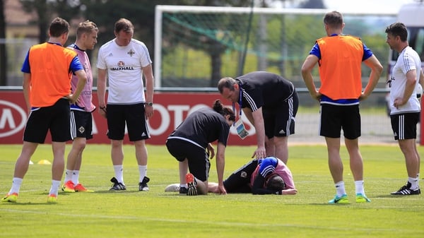 Kyle Lafferty receives medical attention after appearing to suffer a groin injury