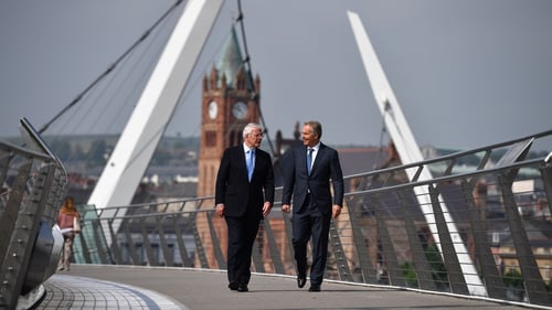 John Major (left) and Tony Blair walk across the Peace Bridge in Derry