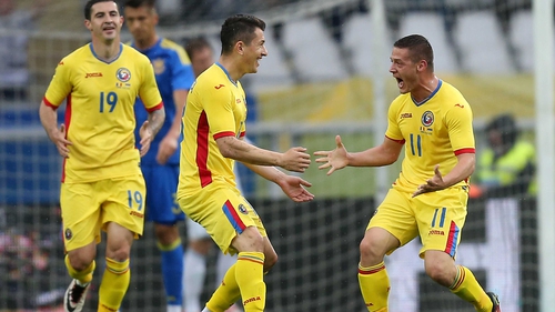 Romania's Gabriel Torje celebrates with Andrei Prepelita after scoring against Ukraine