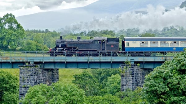 A steam train crosses a bridge in Kerry