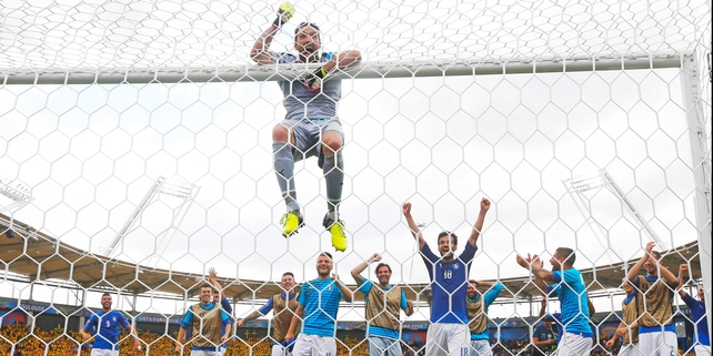 Gianluigi Buffon hangs from the crossbar after victory oiver Sweden