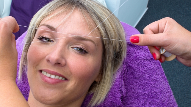 This lass looks very happy with the whole threading process