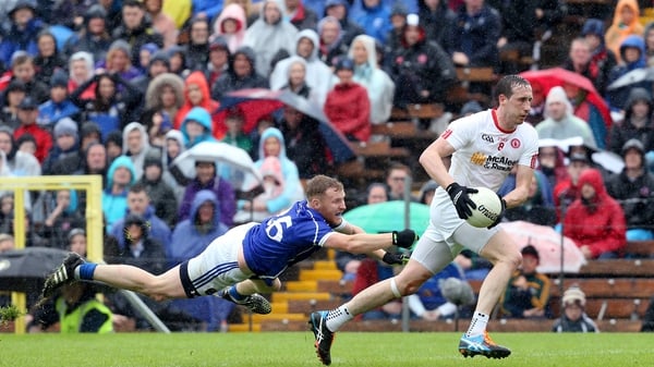 Tyrone's Colm Cavanagh gets away from James McEnroe in the drawn game