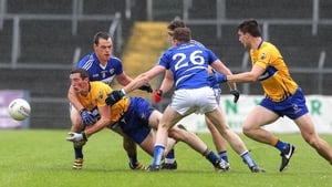 Cathal O'Connor of Clare gets the ball away under pressure