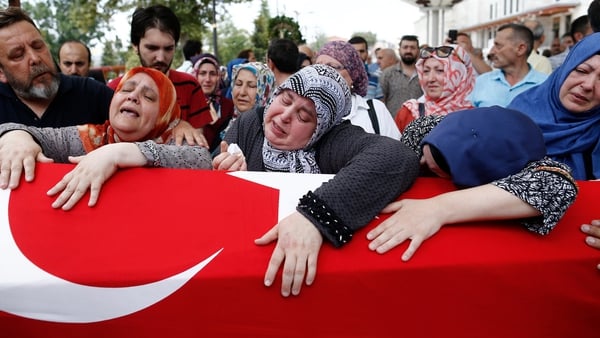 People mourn during the funeral of Omer Can Katar who was killed in the coup attempt