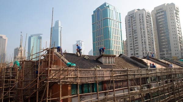 The cut in China's mortgage reference rate comes as a wave of defaults ripples through China's property sector