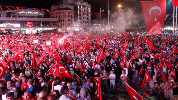 Protesters wave Turkish flags during a demonstration against the failed coup attempt