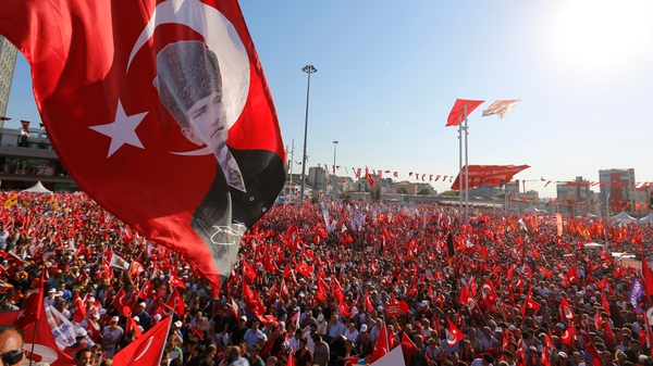 Supporters of main opposition Republic Public Party (CHP) hold Turkish flags and pictures of Ataturk, founder of modern Turkey, during a demonstration at Taksim Square