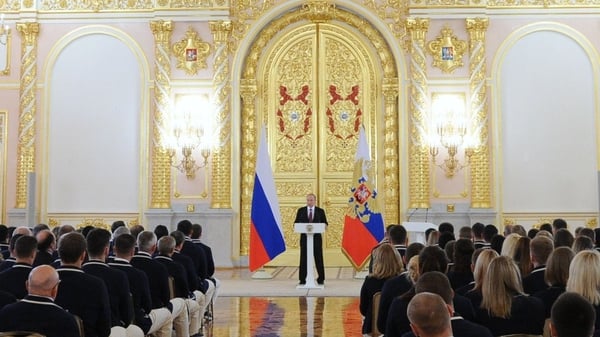 Russian President Vladimir Putin delivers a speech to members of the country's Olympic team