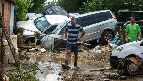A man walks through a flooded street in the village of Stajkovci, near Skopje