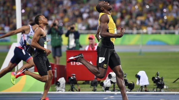 Usain Bolt celebrates as he wins the men's 200m final
