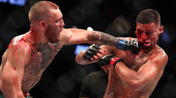 Conor McGregor lands a punch on Nate Diaz at UFC 202