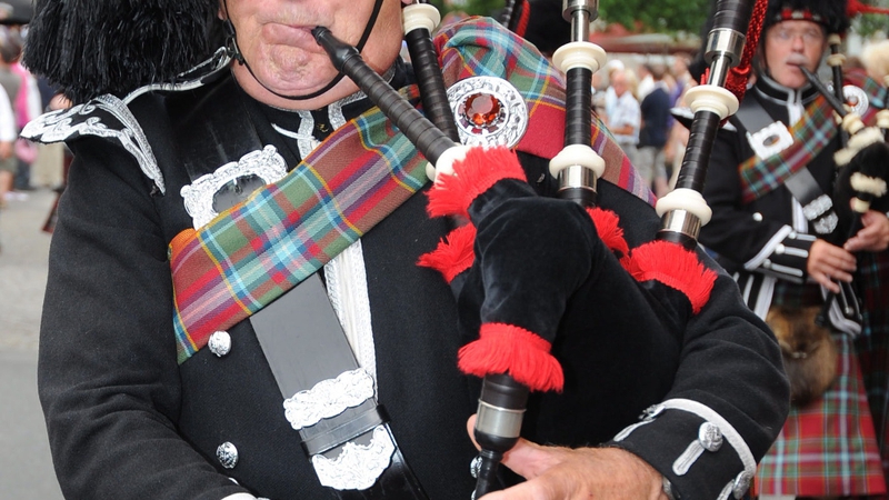 bagpipe player with wind blowing up skirt