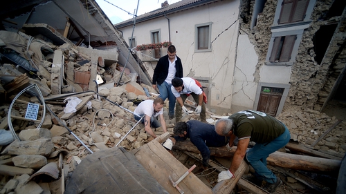 Rescue workers search for people in Amatrice