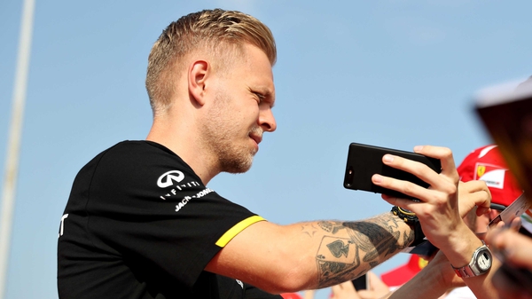 Kevin Magnussen signs autographs before the Grand Prix of Hungary