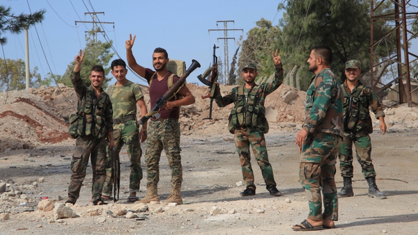 Syrian soldiers on the southern outskirts of Aleppo after regime forces retook control of three military academies from rebel fighters