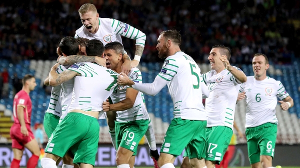 Ireland players mob Daryl Murphy in Belgrade
