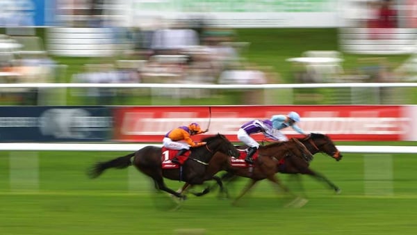 Harbour Law (L) ridden by George Baker comes from behind to win the Ladbrokes St Leger Stakes at Doncaster