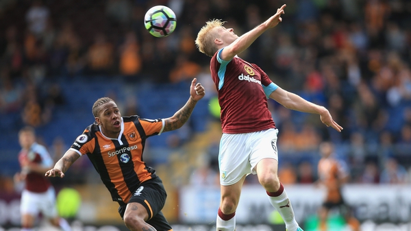 Ben Mee of Burnley (R) attempts to deflect the ball away from Abel Hernandez