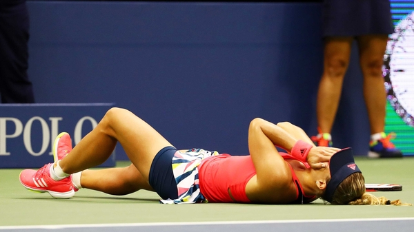Angelique Kerber falls to the ground following victory