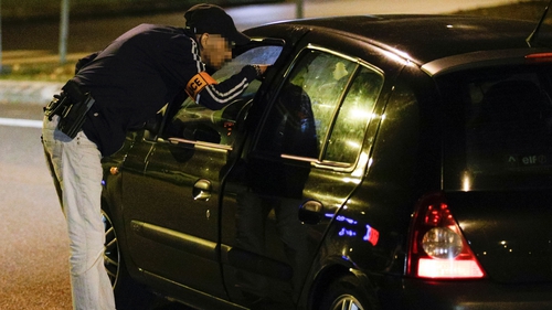 Police search a car near where one of the women was arrested