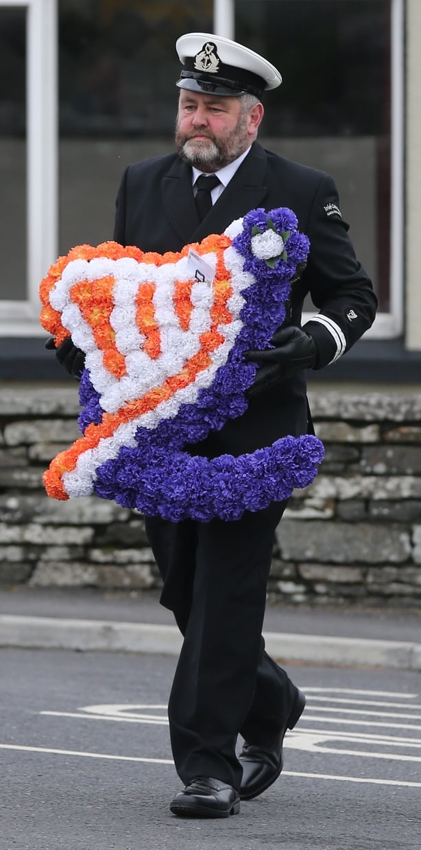 A wreath baring the logo of the Irish Coast Guard