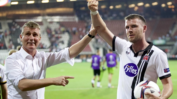 Stephen Kenny holds Ciaran Kilduff's arm aloft as Dundalk acknowledge the role played by their travelling supporters