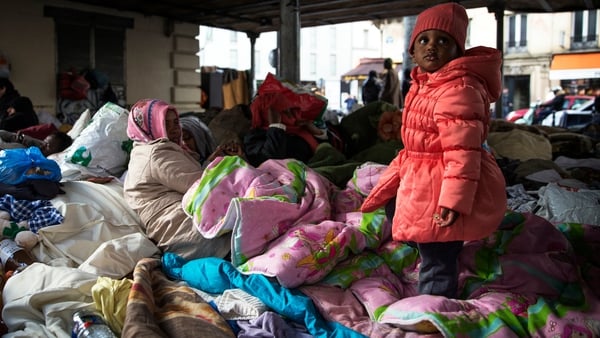 A family from Eritrea is pictured at a makeshift camp in Paris