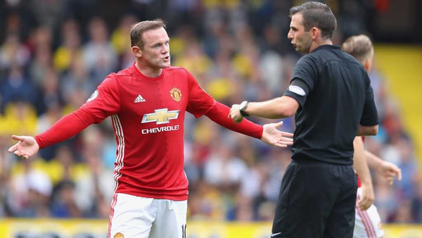 A frustrated Wayne Rooney argues with referee Michael Oliver during the loss to Watford