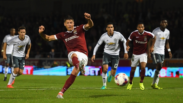 Alex Revell scores from the spot for the home side