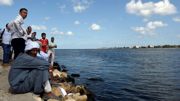 Egyptians in the port city of Rosetta watch a boat departing for the search operation