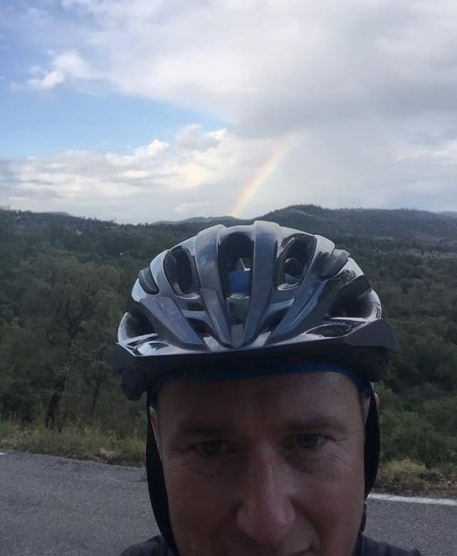 Alone on the mountain with a rainbow.