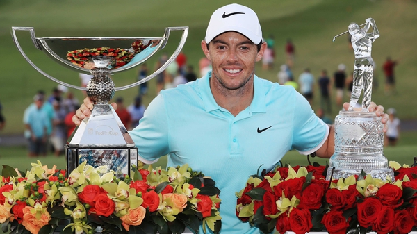 Rory McIlroy poses with the FedExCup and Tour Championship trophies