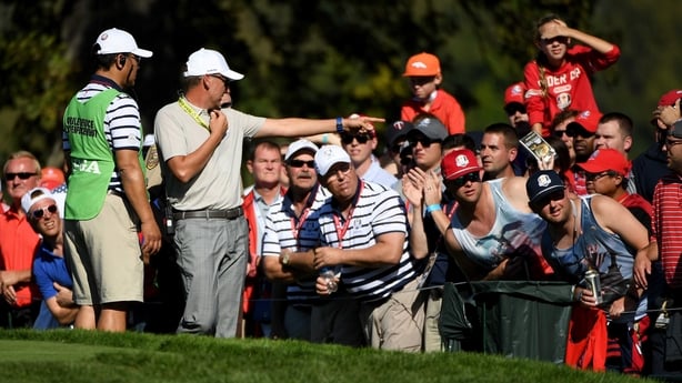 Ian Poulter looks to have a spectator removed