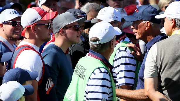 Tom Lehman (R) speaks to US fans heckling Sergio Garcia