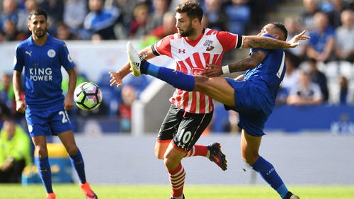 Southampton's Charlie Austin is tackled by Danny Simpson