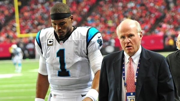 Panthers' Cam Newton leaves the field with the team doctor