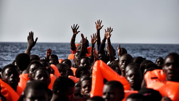 People wait to be rescued as they drift 20 nautical miles north off the coast of Libya
