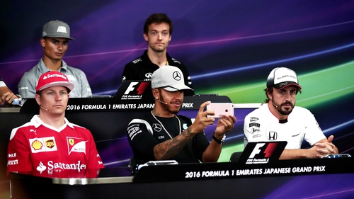 Lewis Hamilton messing on his mobile