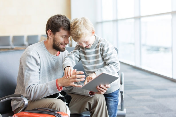 Dad and child playing on tablet