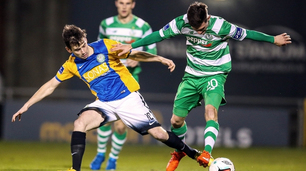 Luke Moore challenges Trevor Clarke for possession
